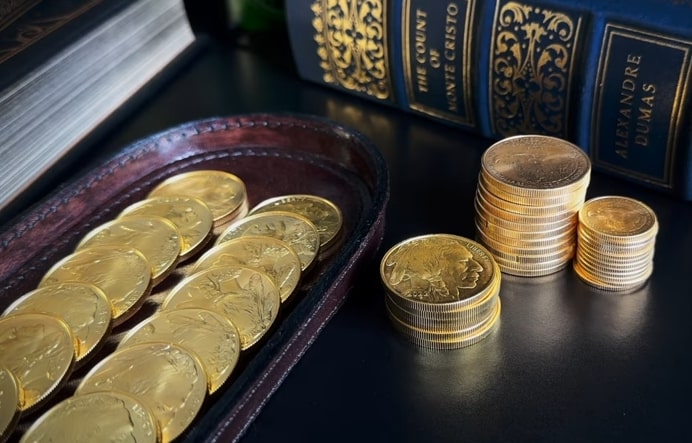 many gold coins and three stacks of gold coins